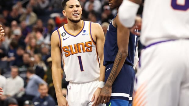 Nov 9, 2022; Minneapolis, Minnesota, USA; Phoenix Suns guard Devin Booker (1) reacts after his teammate Torrey Craig (0) draws a foul during the first quarter at Target Center. Mandatory Credit: Matt Krohn-USA TODAY Sports